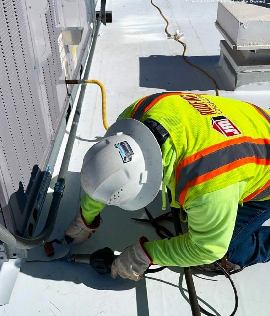 jm roofing aplying roof coating