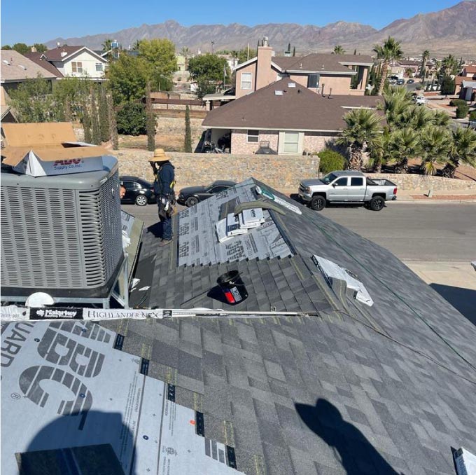 Close-up of an asphalt shingle roofing being secured by a certified GAF Gold Elite contractor.