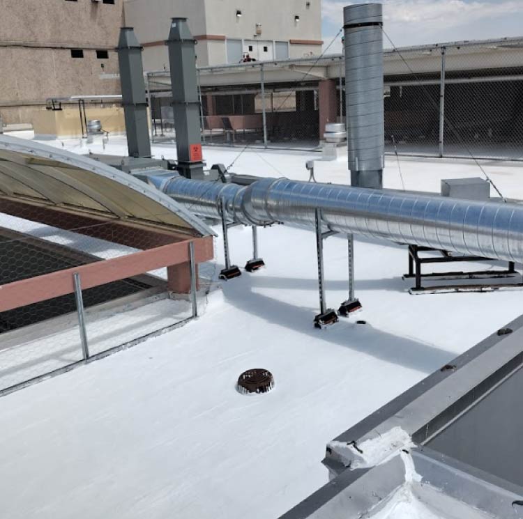 A newly finished commercial TPO after a roof installation in fabens, tx on a building near the Fabens High School football field.