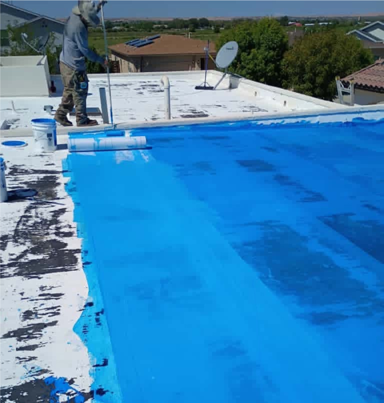 Professional team installing a TPO membrane flat roof system as expert Commercial Roofing Installers on a large El Paso warehouse.