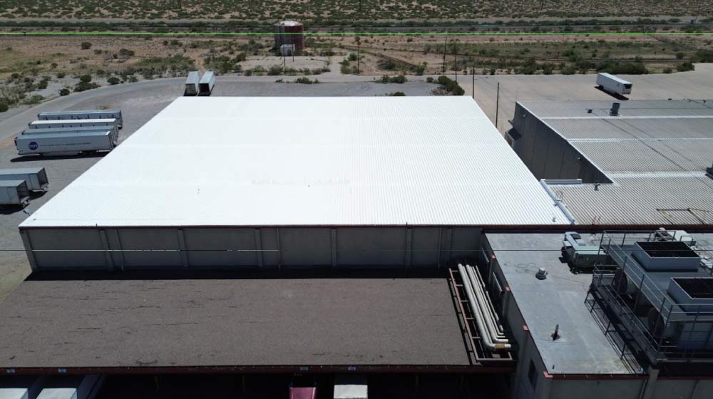 High-quality premium silicone roof coating providing a seamless waterproof barrier on a commercial building.