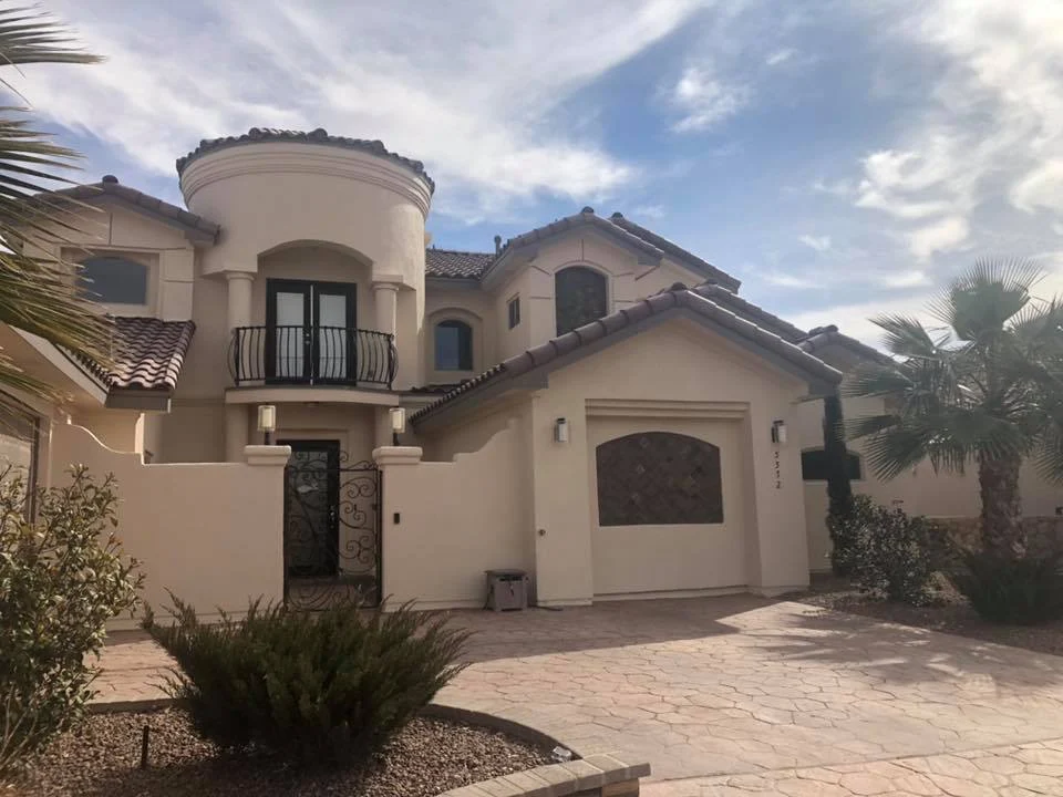 Two-story stucco home with tile roof and fresh stucco finish in El Paso, TX
