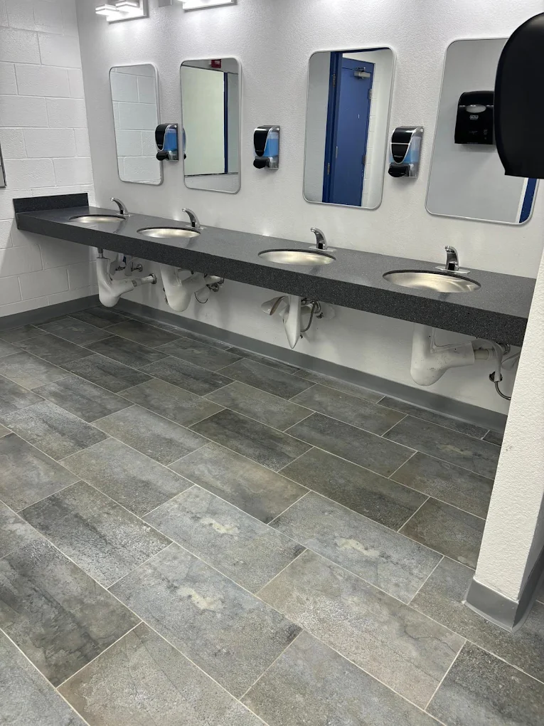 Commercial restroom with new gray porcelain tile flooring installation in El Paso, TX